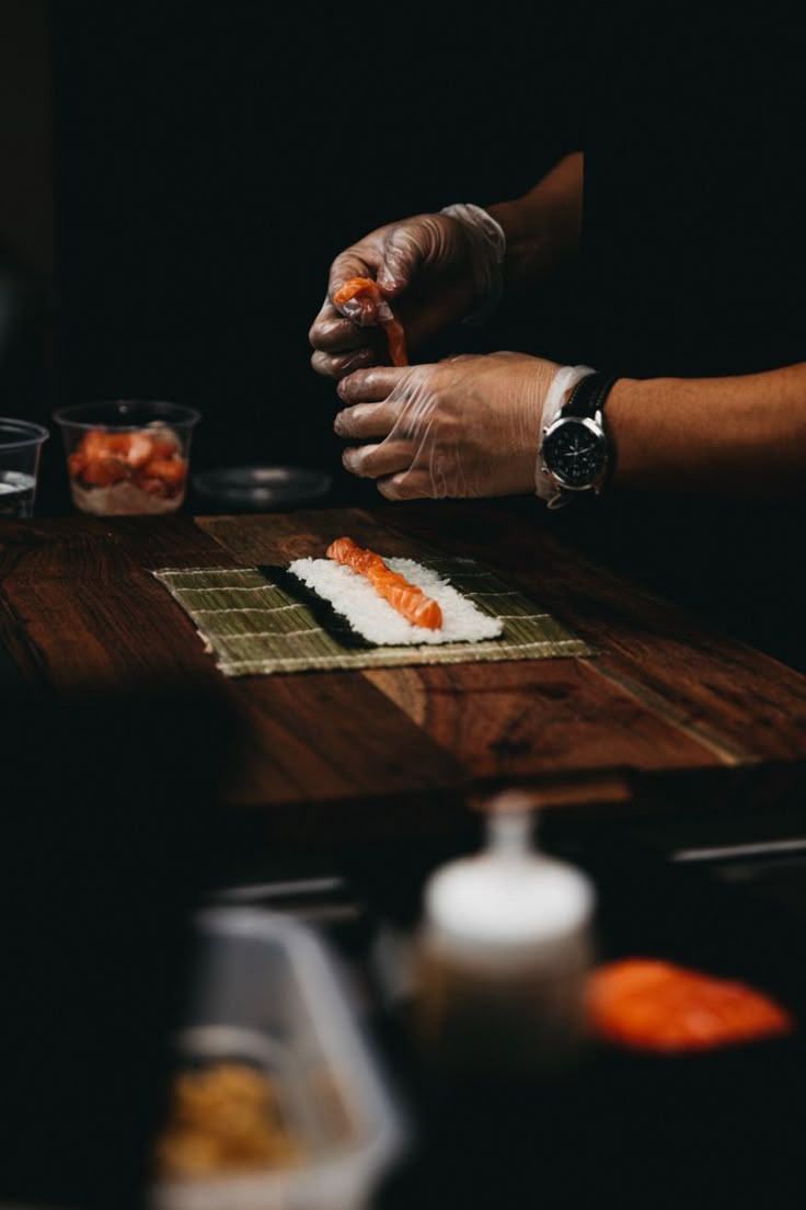 Chef rolling sushi on bamboo mat