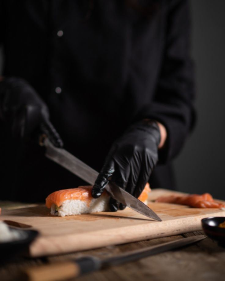Chef slicing salmon nigiri
